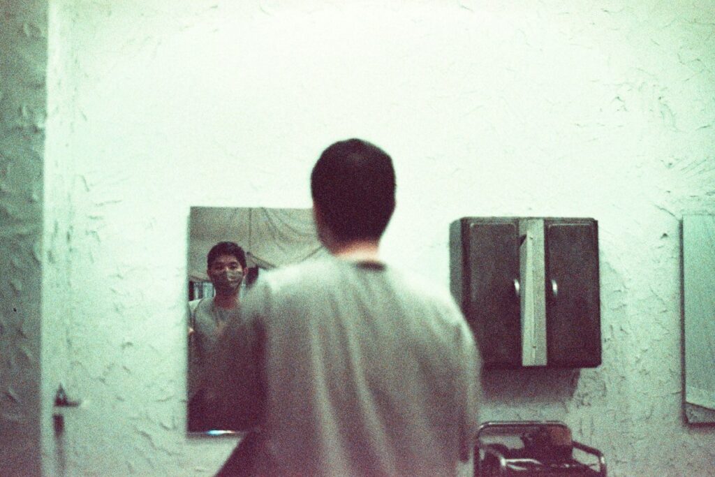 young man looking in the mirror.